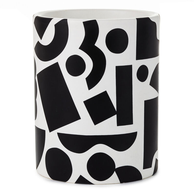 Round ceramic pencil caddy with bold black geometric shapes on a white background.
