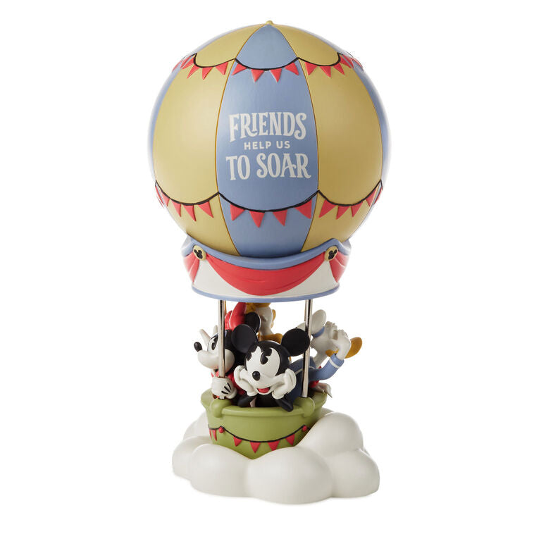 Disney Mickey and Friends resin figurine with Mickey, Minnie, Donald, and Daisy in a hot air balloon on a cloud base.
