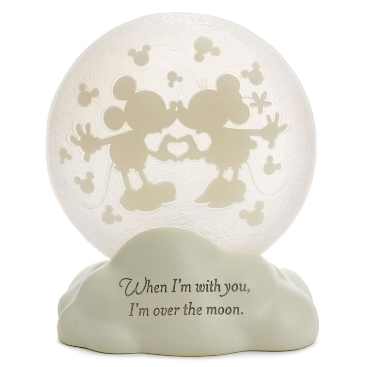Light-up Mickey and Minnie figurine with heart hands silhouette on a frosted moon and “Over the moon” quote on the base.