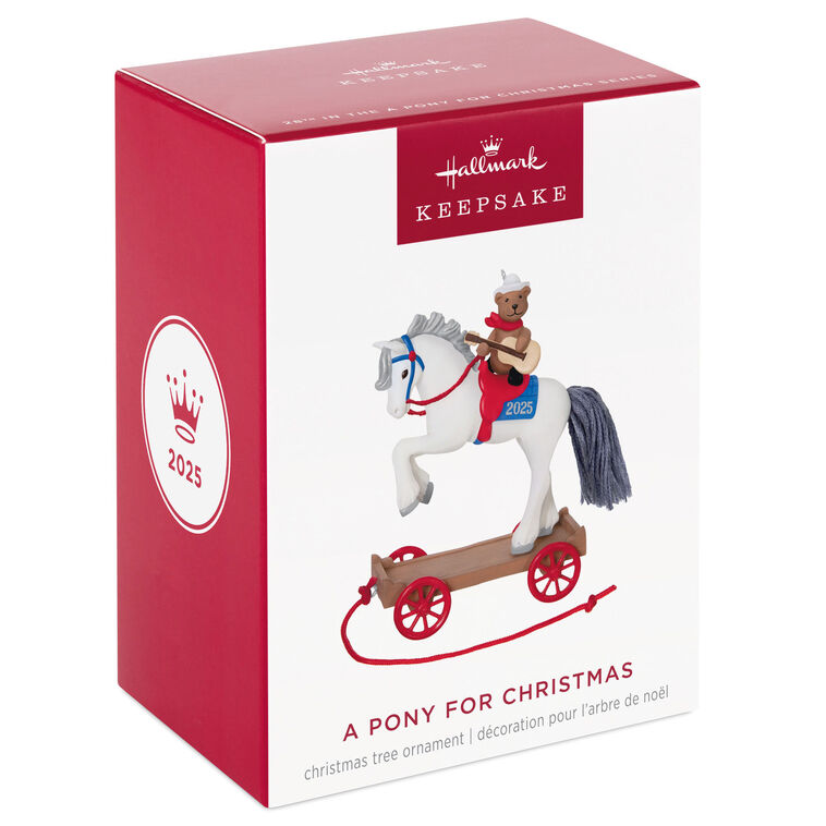 2025 ornament of a teddy bear cowboy on a white pony with red wheels, wearing a hat and scarf, strumming a guitar on a rolling wood-tone base.