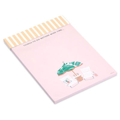 Pink to-do note pad with wine glasses, beach chairs, umbrella, and tropical leaf accents on a striped header.
