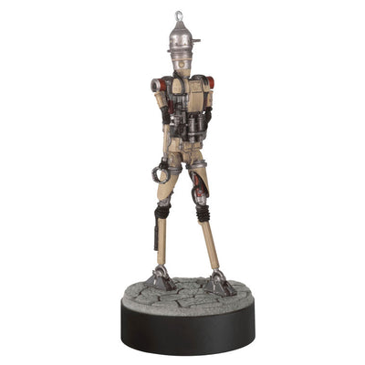 Ornament of Grogu piloting IG-12 droid from Star Wars: The Mandalorian™, on round base with sound button for “Yes” and “No” phrases.