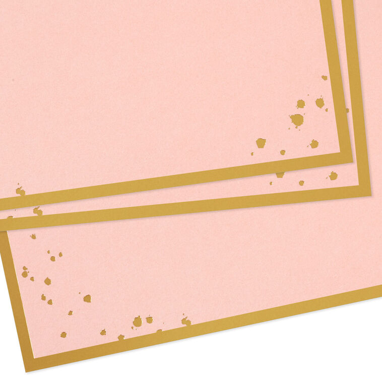 Pink flat note cards with gold foil frame and splatter dot accents, bundled in a kraft wrap.
