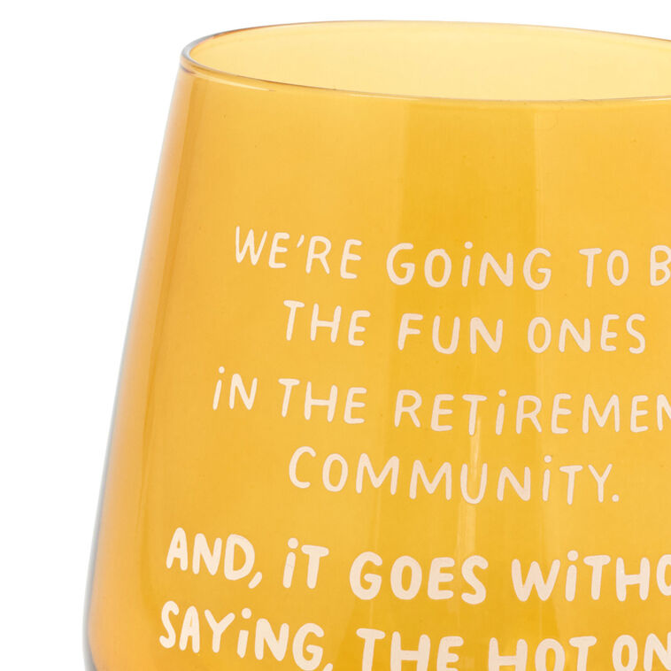 Amber-tinted stemless wine glass with white text: “We&