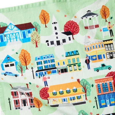 White tea towel printed with a whimsical Stars Hollow map and a central Gilmore Girls quote, includes a loop for hanging.
