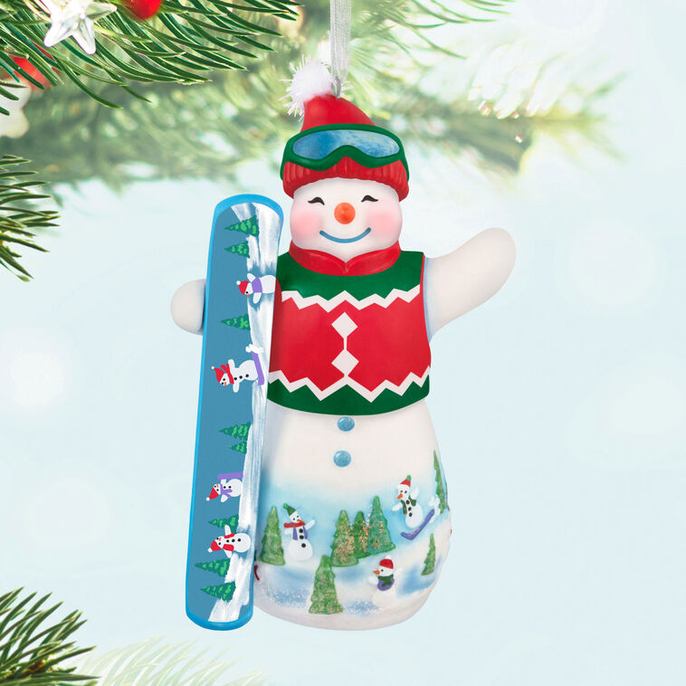 Hallmark Keepsake Ollie U. Halfpipe porcelain snowman ornament in red sweater vest, goggles, stocking hat, holding snowboard, snowy mountain scene