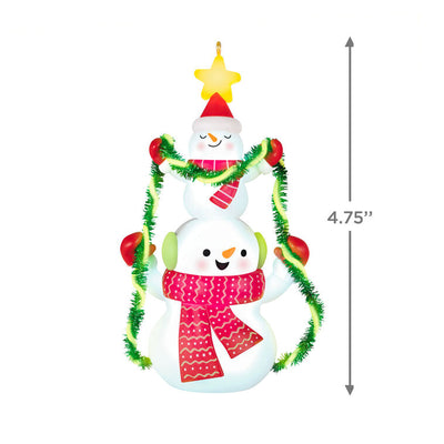 Stacked snowmen Christmas ornament wrapped in green tinsel garland with glowing star, battery operated light-up decor

