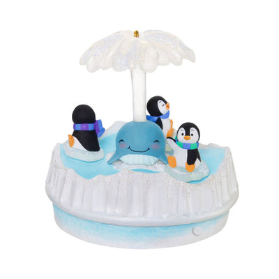 Christmas ornament with three playful penguins spinning on ice pieces around whale, lights and music, battery operated

