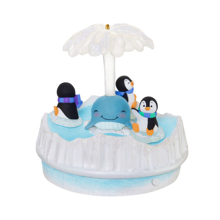 Christmas ornament with three playful penguins spinning on ice pieces around whale, lights and music, battery operated

