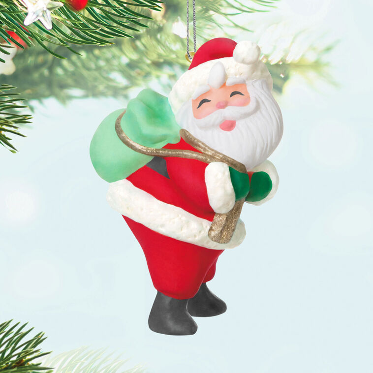 Mini Santa Claus ornament with rosy cheeks and green toy sack, retro-styled Hallmark Keepsake Christmas collectible