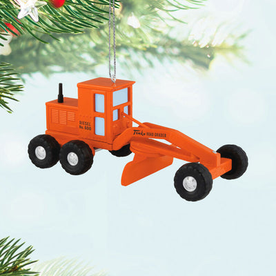 Hallmark Keepsake Hasbro Tonka Road Grader ornament, orange die-cast metal construction vehicle toy with turning wheels, vintage-style design.