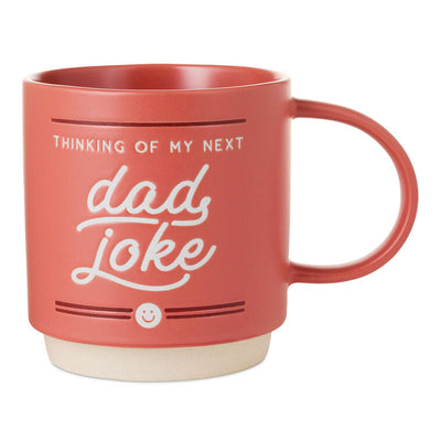 Red ceramic mug with "Thinking of my next dad joke" white lettering, smiley face design, oversized handle