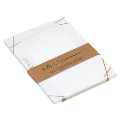 Flat white thank-you cards with intersecting gold foil lines and minimalist “thank you” message.
