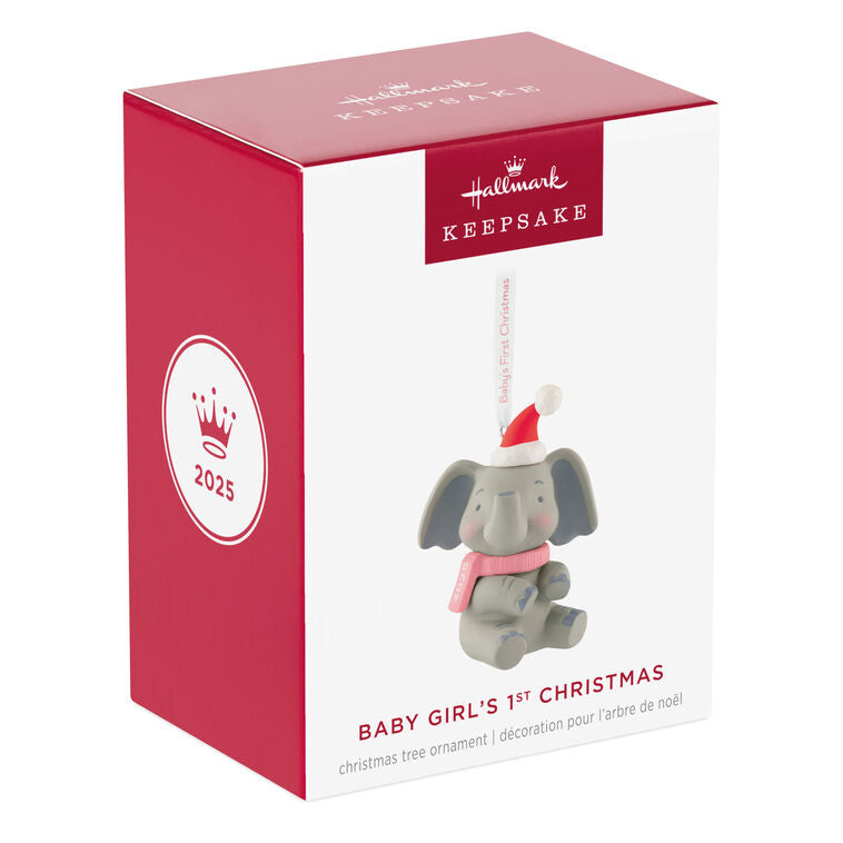 Gray elephant ornament in Santa hat and pink scarf holds a “Baby’s First Christmas 2025” ribbon.