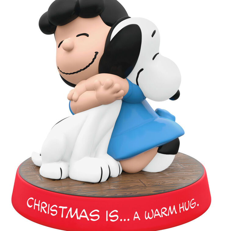 Hallmark Keepsake ornament of Lucy hugging Snoopy, Peanuts Gang Christmas Is series, red base with heartfelt sentiment