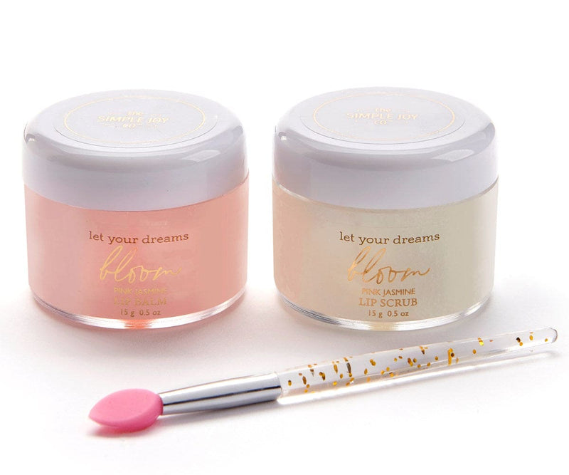 A gift-boxed lip care set with pink jasmine lip balm, lip scrub, and a soft brush labeled “Let Your Dreams Bloom.”

