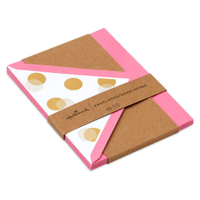 Bright pink envelopes with gold and white halftone dot design inside the flap and pointed edges.

