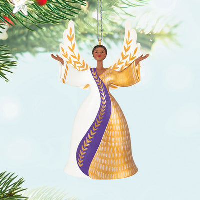 Angel ornament in gold, white, and purple gown with raised hands and detailed wings, a radiant Hallmark Keepsake holiday symbol of faith.