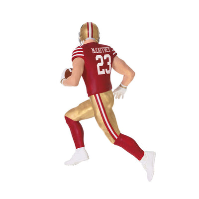 Christian McCaffrey ornament in 49ers red and gold uniform, number 23, action pose with football, Hallmark NFL Christmas collectible
