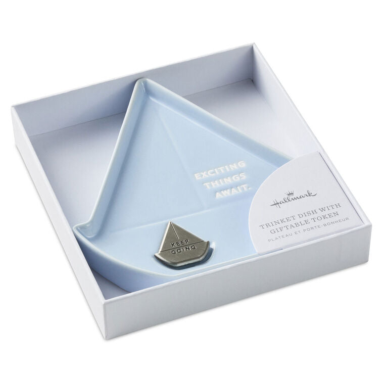 Light blue sailboat-shaped Hallmark trinket dish with removable “Keep going” token and inspiring message.