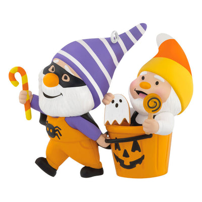 Halloween ornament of two gnomes, one dressed as bat and one with candy corn hat in jack-o'-lantern pail