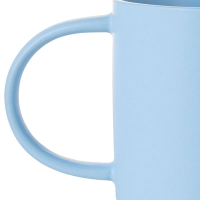 Light blue ceramic mug with “Good things come to those who ask Grandma” text, floral design, and oversized handle.