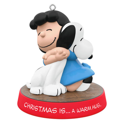 Hallmark Keepsake ornament of Lucy hugging Snoopy, Peanuts Gang Christmas Is series, red base with heartfelt sentiment