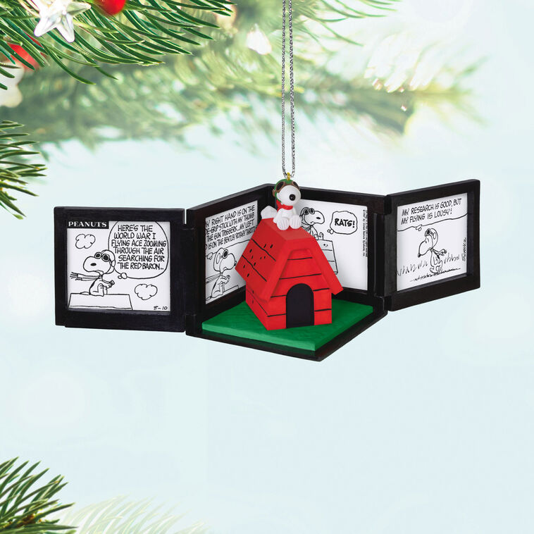 Snoopy as the Flying Ace on red doghouse airplane, comic panel backdrop, Peanuts 75th anniversary Hallmark Christmas musical ornament
