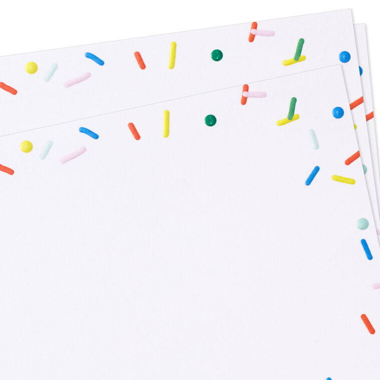 White flat note cards with colorful confetti sprinkle border design, bundled in kraft paper wrap.
