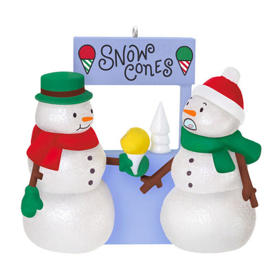 Humorous snowman Christmas ornament offering yellow snow cone to surprised snowperson