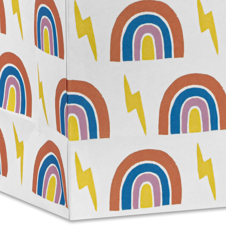 Small Hallmark gift bag with colorful rainbows and yellow lightning bolts on a white background with yellow ribbon handles.