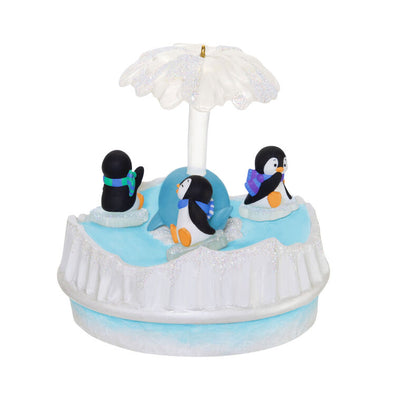Christmas ornament with three playful penguins spinning on ice pieces around whale, lights and music, battery operated

