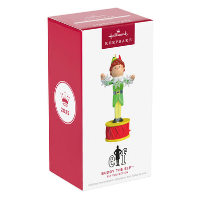 Buddy the Elf ornament with light and sound, standing on red base in green costume with snowflakes, inspired by the movie “Elf”