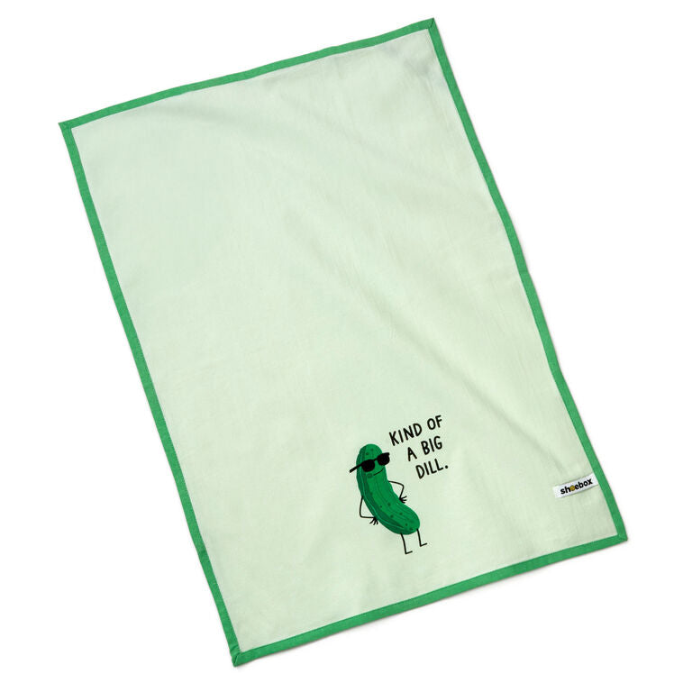 White tea towel with green border, featuring a dill pickle in sunglasses and the phrase: “Kind of a big dill.”