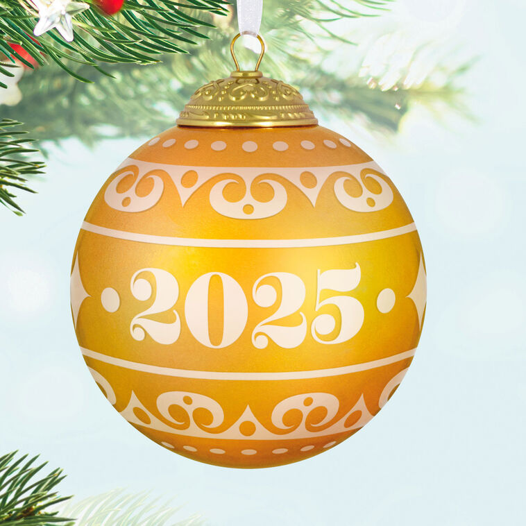 Hallmark Keepsake Christmas Commemorative 2025 ornament—yellow frosted glass ball with elegant gold scroll design, embossed metal cap, and “2025