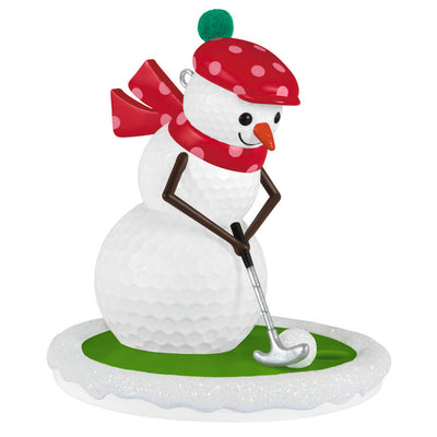 Golf ball snowman ornament in red polka dot hat and scarf, hitting a snowball with a silver putter

