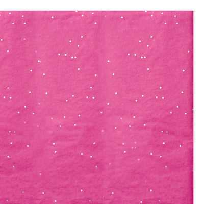 Hot pink Hallmark tissue paper with shimmering iridescent dots, displayed folded and fluffed in a gift bag.