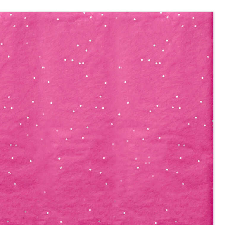 Hot pink Hallmark tissue paper with shimmering iridescent dots, displayed folded and fluffed in a gift bag.