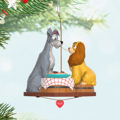 Lady and the Tramp 70th anniversary ornament featuring the Cocker Spaniel and stray dog sharing a spaghetti supper.

