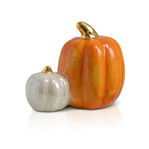 A ceramic mini pumpkin with warm pumpkin spice colors, perfect for fall and seasonal décor.

