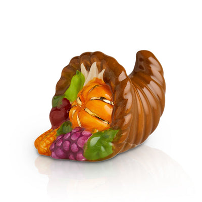 A ceramic mini featuring autumn harvest elements like pumpkins and leaves, perfect for Thanksgiving décor.

