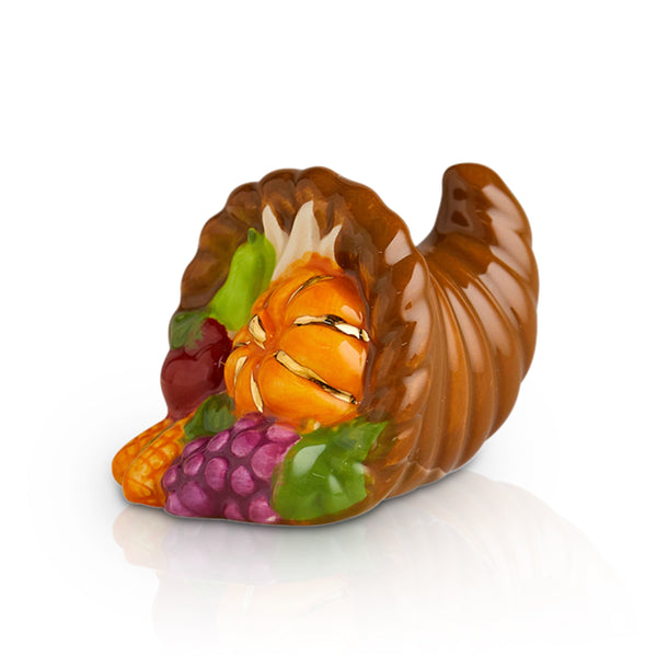 A ceramic mini featuring autumn harvest elements like pumpkins and leaves, perfect for Thanksgiving décor.

