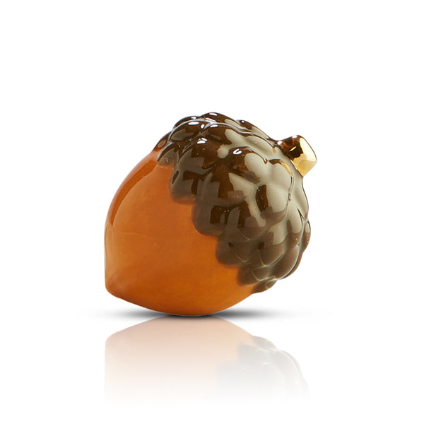 A ceramic mini acorn with detailed design, perfect for autumn and fall-themed table décor.

