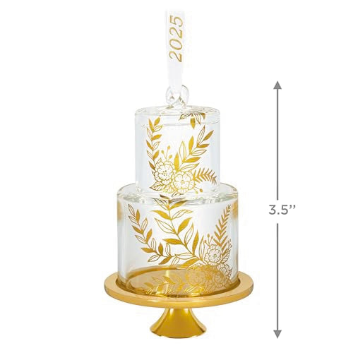 Glass wedding cake ornament with gold leaf and floral accents on clear tiers, featuring “2025” and gold base for newlywed Christmas keepsake.