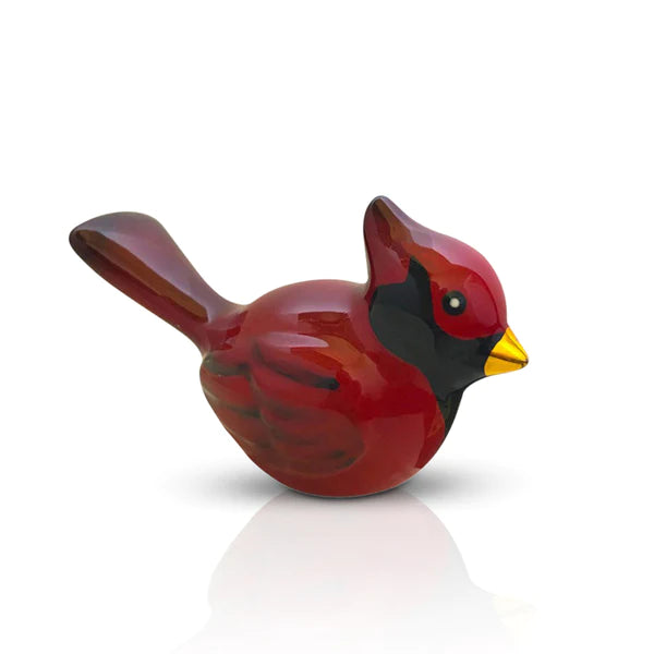 Red cardinal figurine on a white background