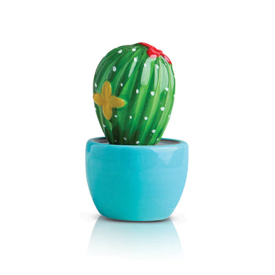 Blue pot with a prickly pear cactus and a butterfly on a white background