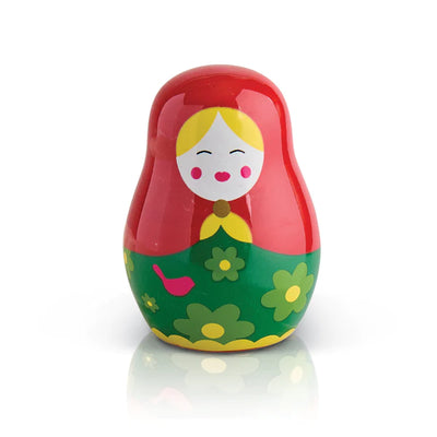 Red and green ceramic doll with reflection on white background