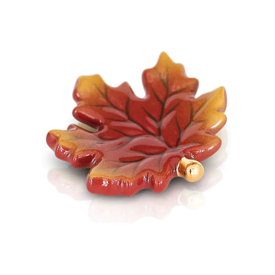 Red maple leaf with gold stem on white background