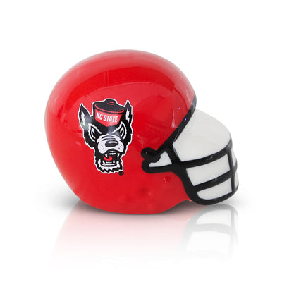Nora Fleming North Carolina State football helmet mini; red and white sports-themed accent for tailgating; hand wash only.

