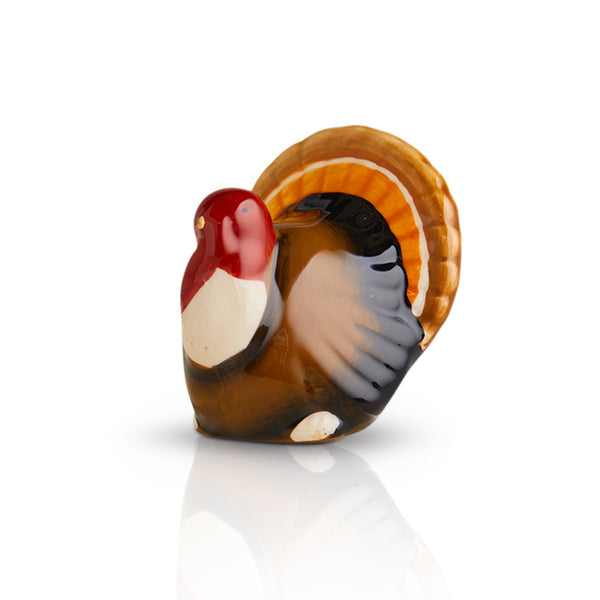 Nora Fleming turkey-shaped mini with festive colors; a charming addition to Thanksgiving table decor; hand wash only.

